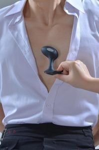 Adult man relaxing after using a male prostate Electro Shock Series device for stress relief